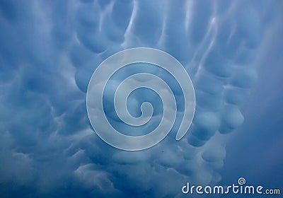 Storm clouds of fluffy puffy shape the beginning of a bubble-shaped thunderstorm, steel-gray color thunderstorm cell in the sky. h Stock Photo