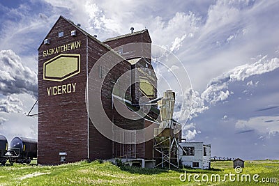 Storm clouds over an abandoned grain elevator in Viceroy Saskatchewan, Canada Editorial Stock Photo