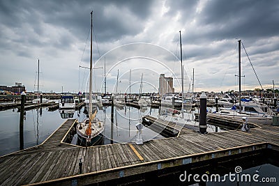 Storm clouds over docks and boats in Harbor East, Baltimore, Mar Editorial Stock Photo