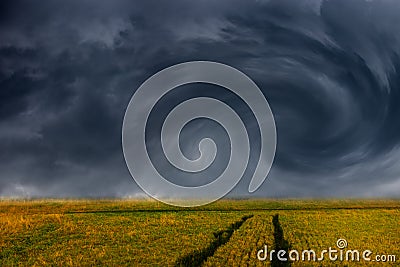 Storm clouds over field Stock Photo