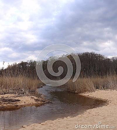 Storm Clouds Over Scenic Estuary Cast Somber Tone Stock Photo