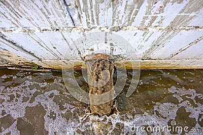 Storm Drain Outflow of stormwater, water drainage. Dirty water discharged into river top view Stock Photo