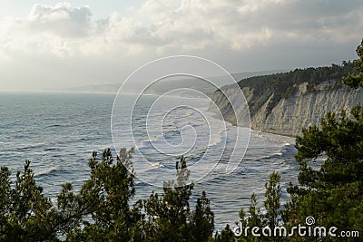 Storm sea waves beat on the rocky shore. The top view. Stock Photo