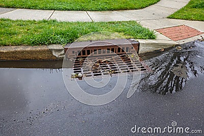 Storm sewer designed to carry excessive surface water from impervious surfaces such as paved roads into the drainage system. Stock Photo