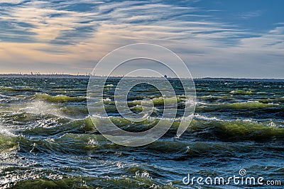 Stormy breaking sea wave with wind spray Stock Photo