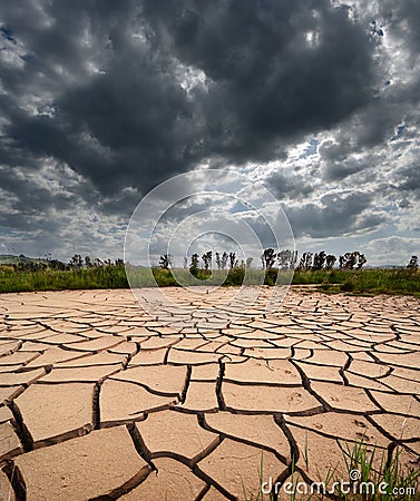 Stormy Clouds And Cracked Land Stock Photo