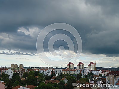 Stormy grey clouds over the city in september. Stormy weather. Stock Photo