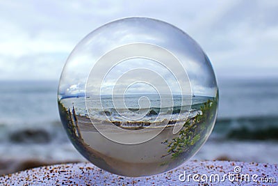 Stormy shore captured in Glass or Crystal Ball Stock Photo