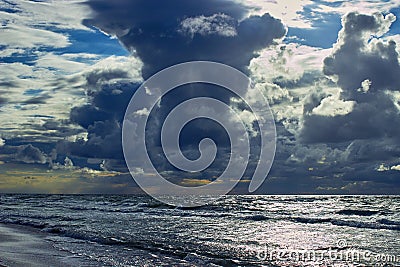 Stormy sunset on the ocean. Glare on the water Stock Photo