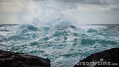 Stormy weather on the sea. Big waves strike against shallow water Stock Photo