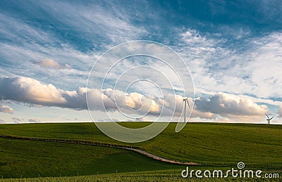 Stormy weather in the spring, clouds in the sky, green meadow, agriculture in Germany, landscape, wind energy and environment Stock Photo