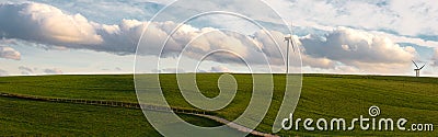 Stormy weather in the spring, clouds in the sky, green meadow, agriculture in Germany, landscape, wind energy and environment Stock Photo