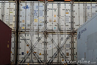 Stowed white reefers containers from different shippers secured on hatch covers of the ship and lashes with lashing bars. Editorial Stock Photo