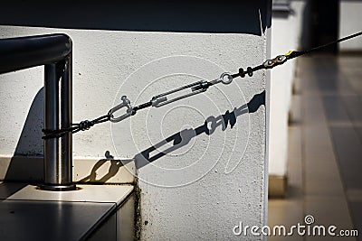 Straight chain holding building structure with dark shadow Stock Photo