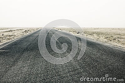 straight desert road leading to the distant void Stock Photo