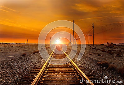Straight railroad heading west towards the sunset somewhere in Utah Stock Photo
