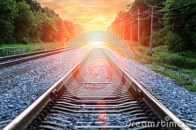 Straight Railroad into sunset with clouds in sky Stock Photo