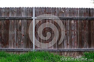 Straight view of old wooden fence between neighbors Stock Photo
