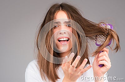 Straightening woman and treatment of the hair. Girl with straight brushed hair. Hair tangling problem. Unhappy girl with Stock Photo