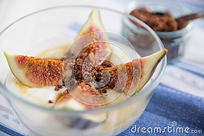 Strained yogurt with sliced figs and honey Stock Photo