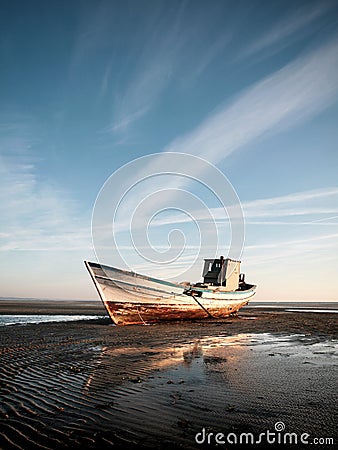 Stranded boat on the beach Stock Photo