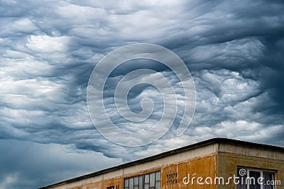 Strange clouds above an old building Stock Photo