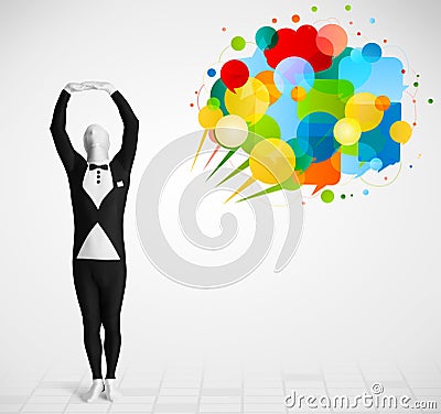 Strange guy in morphsuit looking at colorful speech bubbles Stock Photo