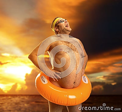 Strange naked man on the beach Stock Photo