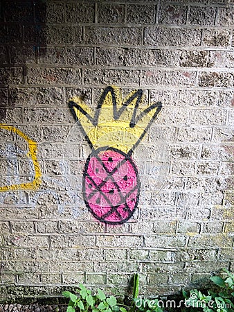 Strange pink and yellow spray painted graffiti logo on underpass Stock Photo