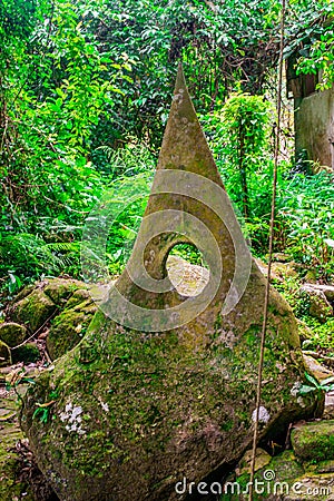 Strange sculpture in the shape of triangle in the magical garden tropical forest at Koh Samui. Thailand Stock Photo