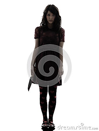 Strange young woman killer holding bloody knife silhouette Stock Photo