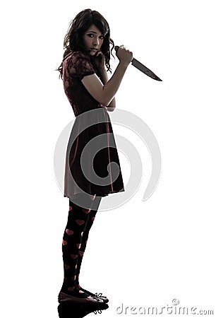Strange young woman killer holding bloody knife silhouette Stock Photo