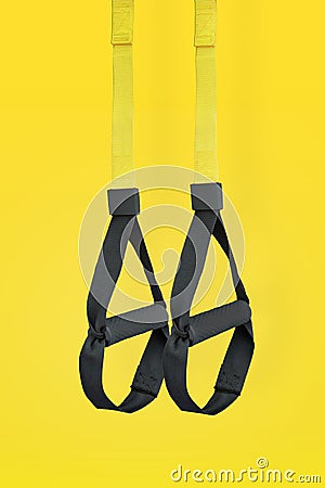Straps training loop.Functional training equipment on yellow background. Sport accessories Stock Photo