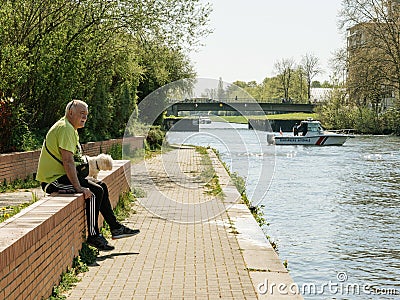 Senior man looking at police boat Editorial Stock Photo