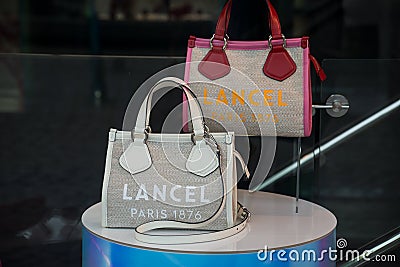 Closeup of colorful leather handbags by Lancel, the famous luxury french brand in a fashion store showroom Editorial Stock Photo