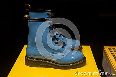 Blue leather doc martens boots in a fashion store showroom Editorial Stock Photo