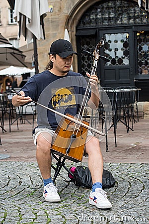 Portrait of musician playing traditional Mongolian violin in the street Editorial Stock Photo