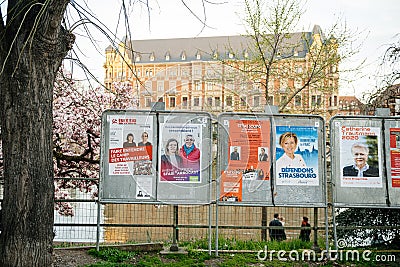 Candidats electoral campaign poster near polling station during first round of Editorial Stock Photo