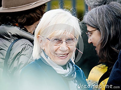 A smiling woman looking at the camera in fornt of Court for Human Rights, Editorial Stock Photo