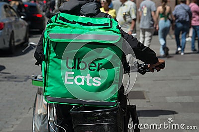 Portrait of uber eats delivery man in bicycle waiting in the street Editorial Stock Photo
