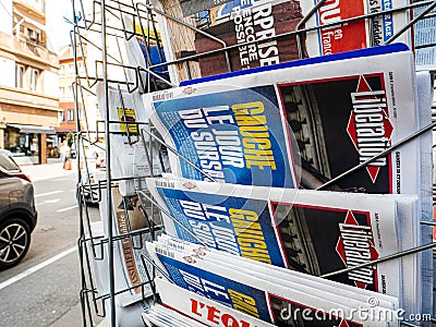 Newspaper kiosk stand with pedestrian reading Liberation Editorial Stock Photo