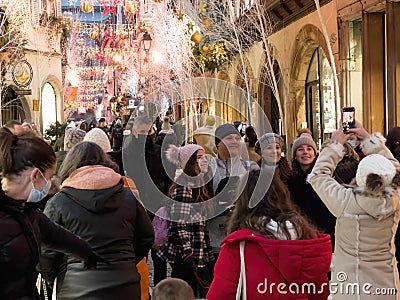 Friends family pedestrians tourists taking group photo with Christmas Market Editorial Stock Photo