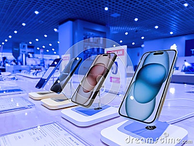 Row of iPhone 15 Pro Smartphones with FNAC Store Background Editorial Stock Photo