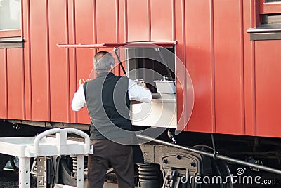 STRASBURG, PA - DECEMBER 15: Conductor exchanging dining supplies on dining car in Strasburg, Pennsylvania on December Editorial Stock Photo