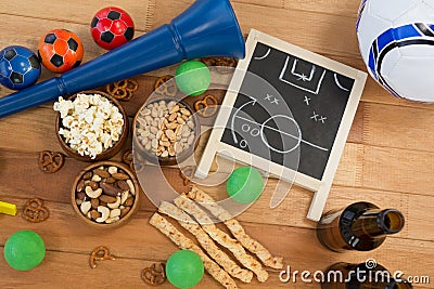 Strategy board, snacks, drink and football on wooden table Stock Photo