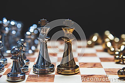 Strategy of leadership as king facing each other in wooden chess board in checkmate position. Business marketing of competition Stock Photo