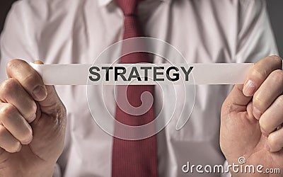 Strategy word in hands of businessman. Concept of strategical planning Stock Photo