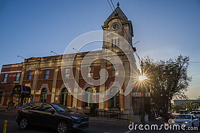 Strathcona Public Building - an old brick house with a tower and clock. Old post office. Amazing sunset, sun rays, clear sky. Editorial Stock Photo