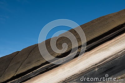 Stratified, striped rocks , colored stone sediment Stock Photo