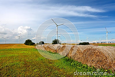 Straw bales and wind turbines Stock Photo